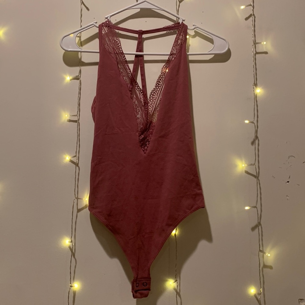NEW with tags. Express Purple XS bodysuit with lace design.